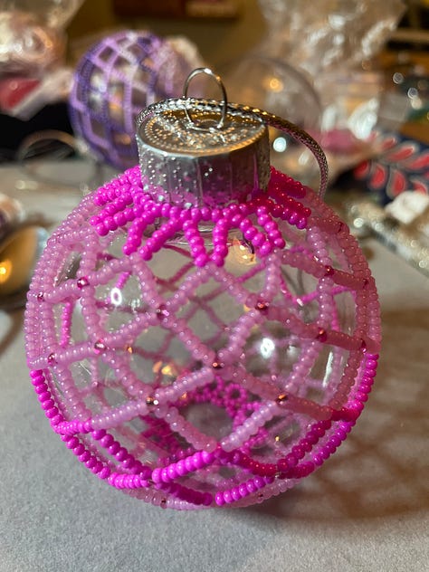 Beaded holiday ornaments, pinback buttons and knitted hats