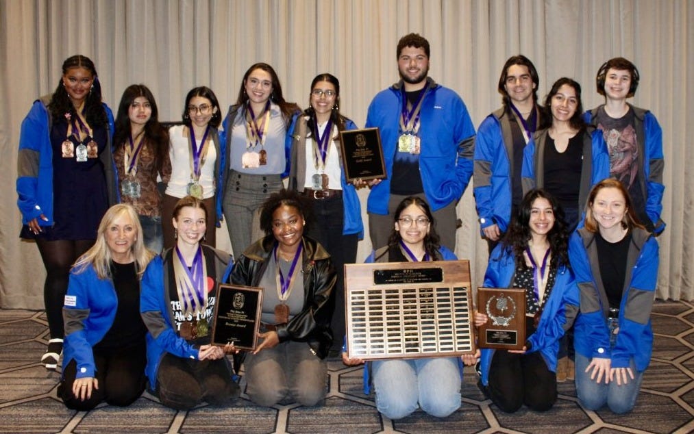 The El Camino College Speech and Debate team gather for a picture, holding their awards and wearing their team jackets, after the awards ceremony at the 2025 Phi Rho Pi National Tournament in Norfolk, Virginia, on Sunday, March 16. (Back L-R) Nia Gordon, Abigail Sucup, Danielle Kabboul, Ashley Singh, Sophia Cruz, Andres Osorio, Ethan Syring, Julissa Celis and Alec Lyons. (Front L-R) communication studies professor and coach Francesca Bishop, Abigail Morey, Zaynah Robb, Salma Kidwai, Juliette Celis, communication studies professor and coach Brittany Hubble. (Photo courtesy of Brittany Hubble)