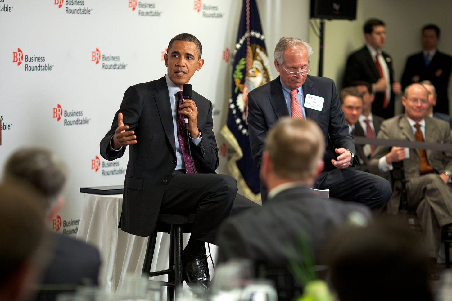 A photograph of President Barack Obama speaking to the Business Roundtable in 2012. A photograph of President Barack Obama speaking to the Business Roundtable in 2012.