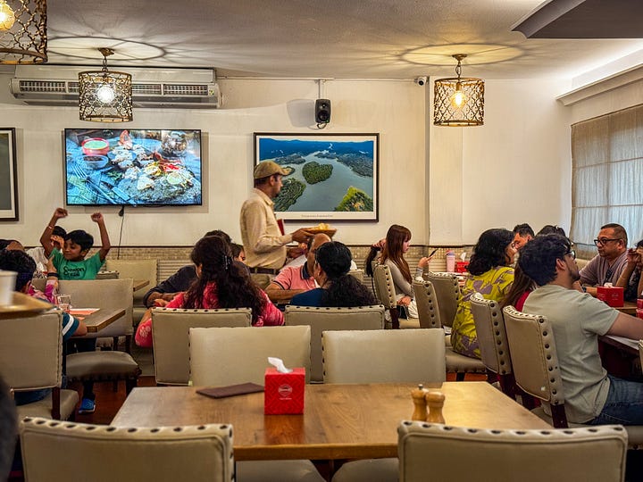 Calicut Paragon from the outside and just one of the restaurant rooms.