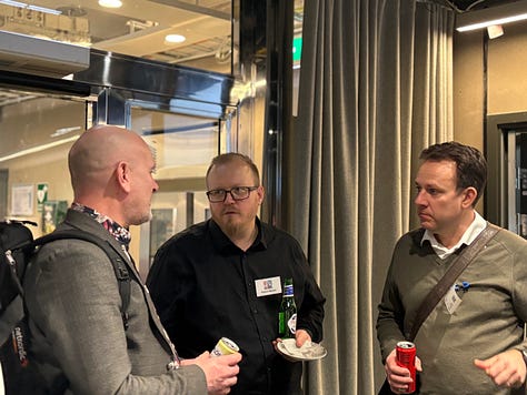 Participants networking, listening to talks, and discussing agents and data engineering during a community night at Google.