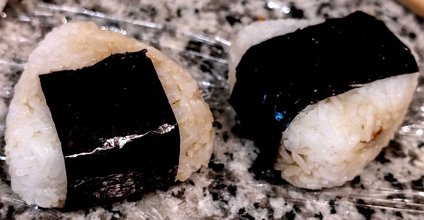 Two onigiri, wrapped in nori Two onigiri, wrapped in nori