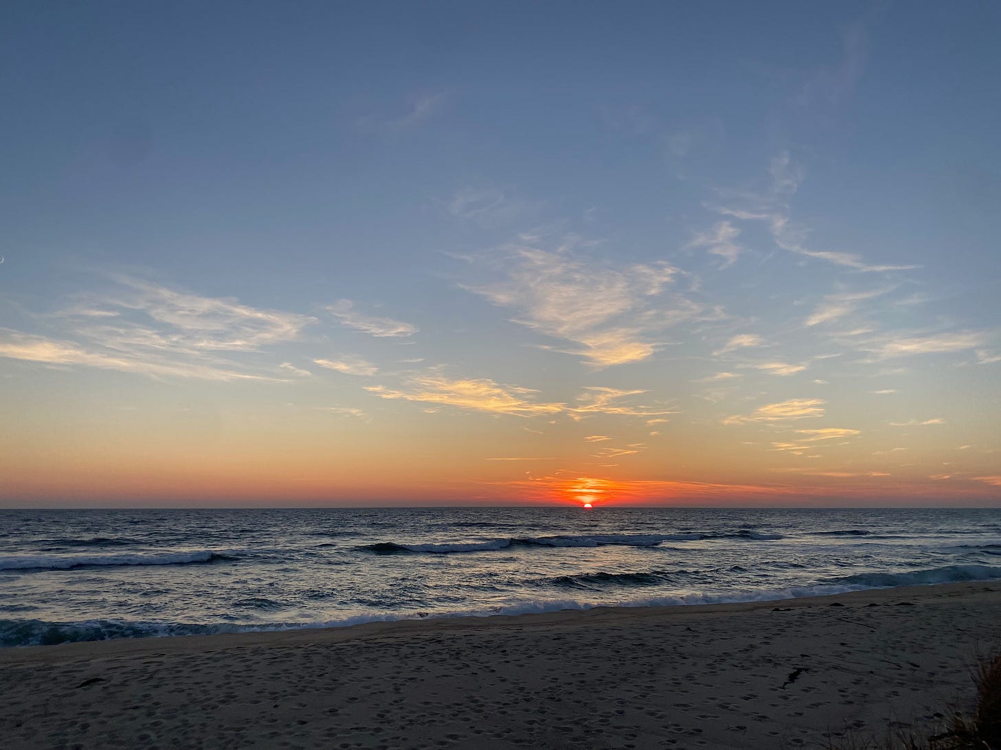 The sun setting over the ocean.