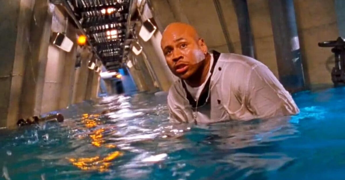 LL Cool J sloshes through aquamarine floodwater in the lab corridor, evading a shark while searching for his parrot.