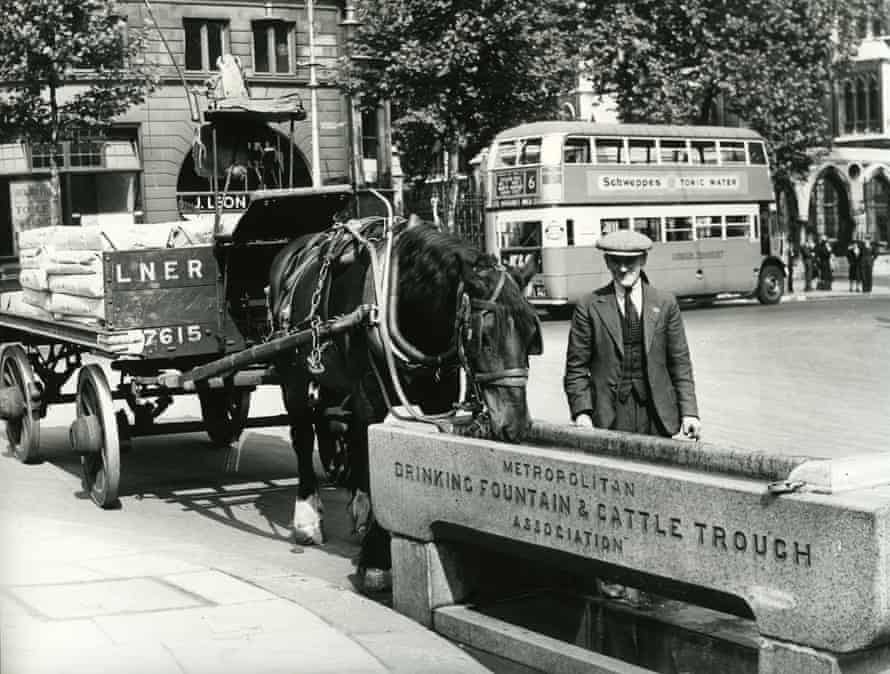 Horse-drawn and motorised traffic in London in the 1930s.