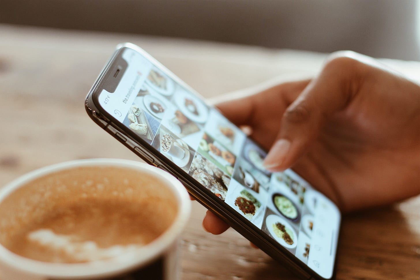 Someone scrolling Instagram on a phone.