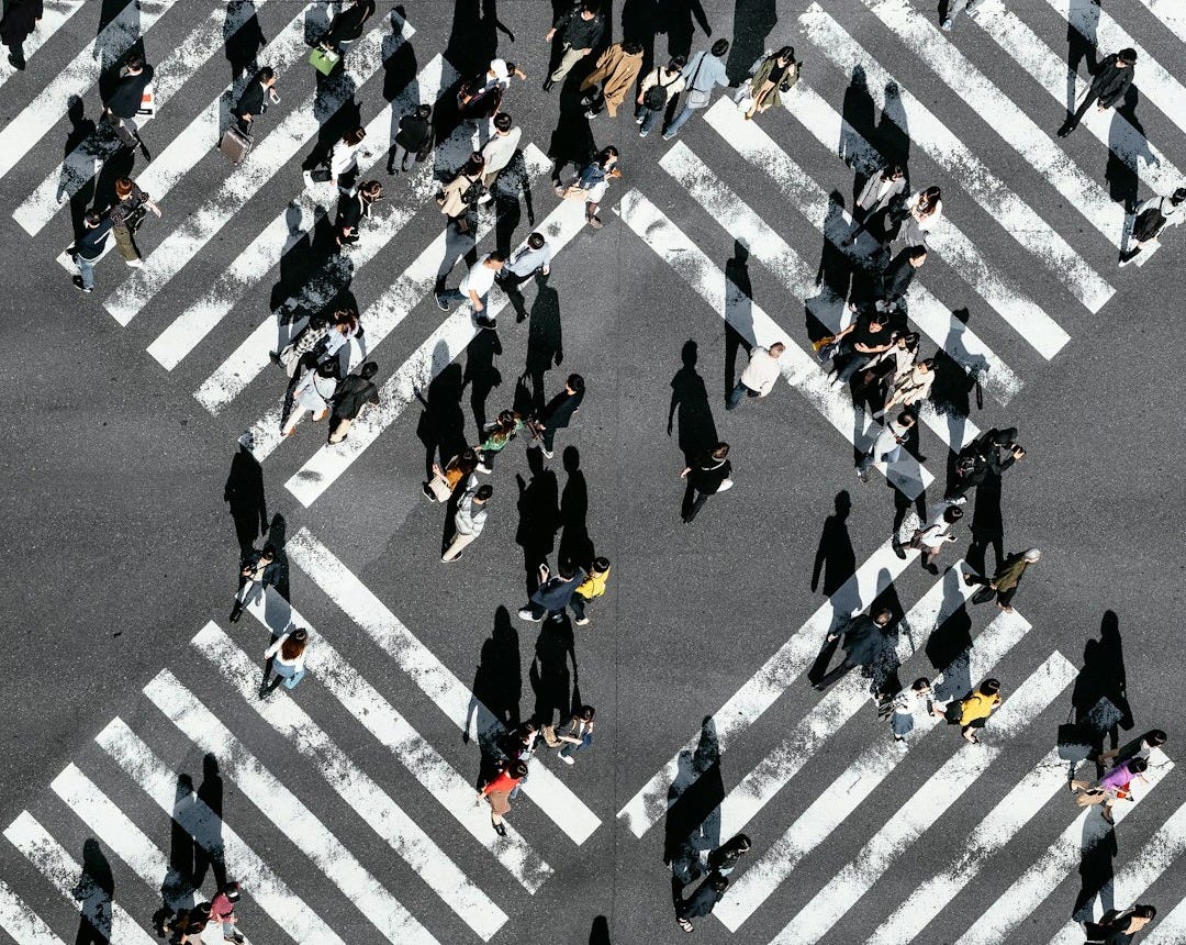 aerial view of people walking on cross pedestrian lane