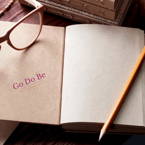 A journal with a pencil and glasses on top and words generating and filling the right hand page. A journal with a pencil and glasses on top and words generating and filling the right hand page.