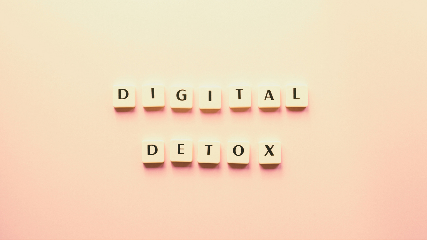 Scrabble tiles spelling ‘Digital Detox’ on a soft pastel background, representing the concept of taking a break from technology for improved mental clarity and well-being.