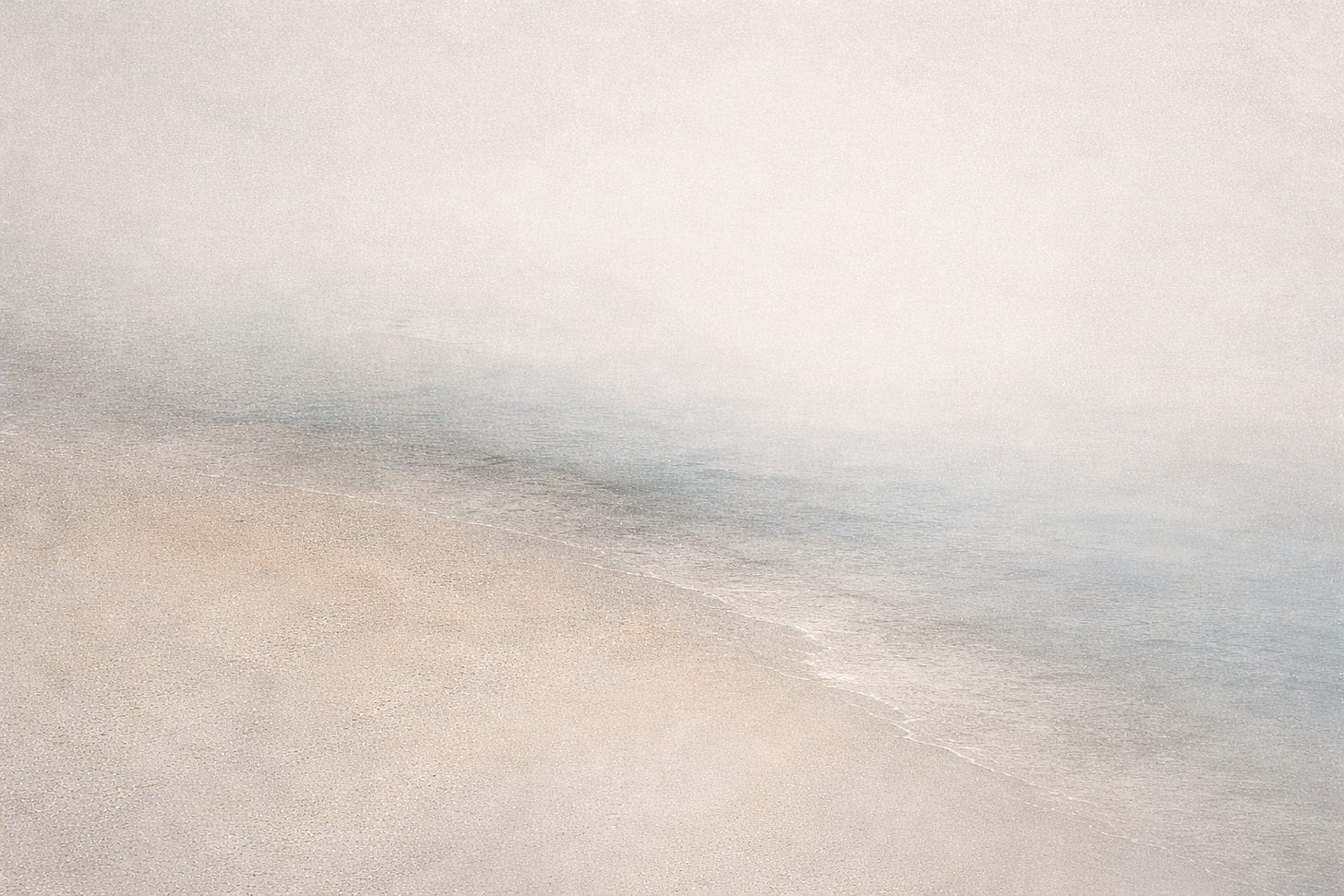 Abstract image of two soft, pale textures blending together with no clear boundary, in muted neutral tones.