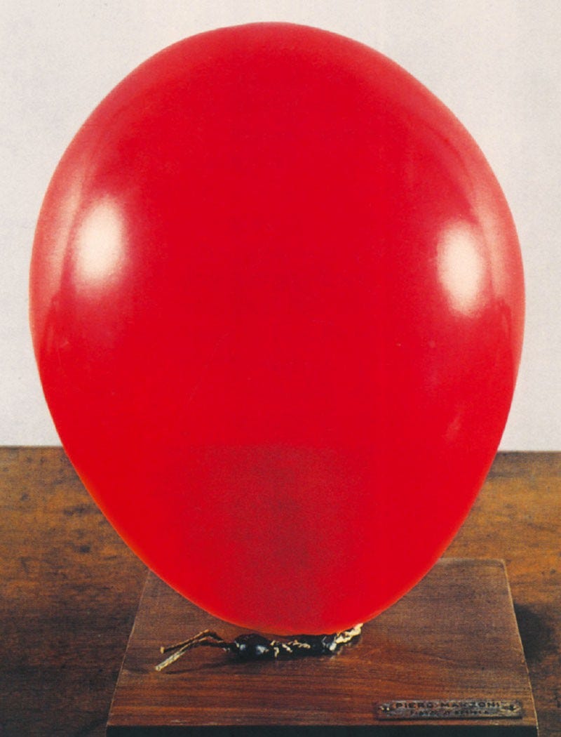 Piero Manzoni’s work Artist’s Breath: a red balloon tied to a rectangular block of wood