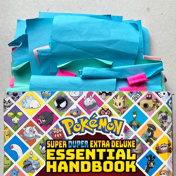 A photo of a book about Pokemon with dozens of post-it notes peaking out of the top
