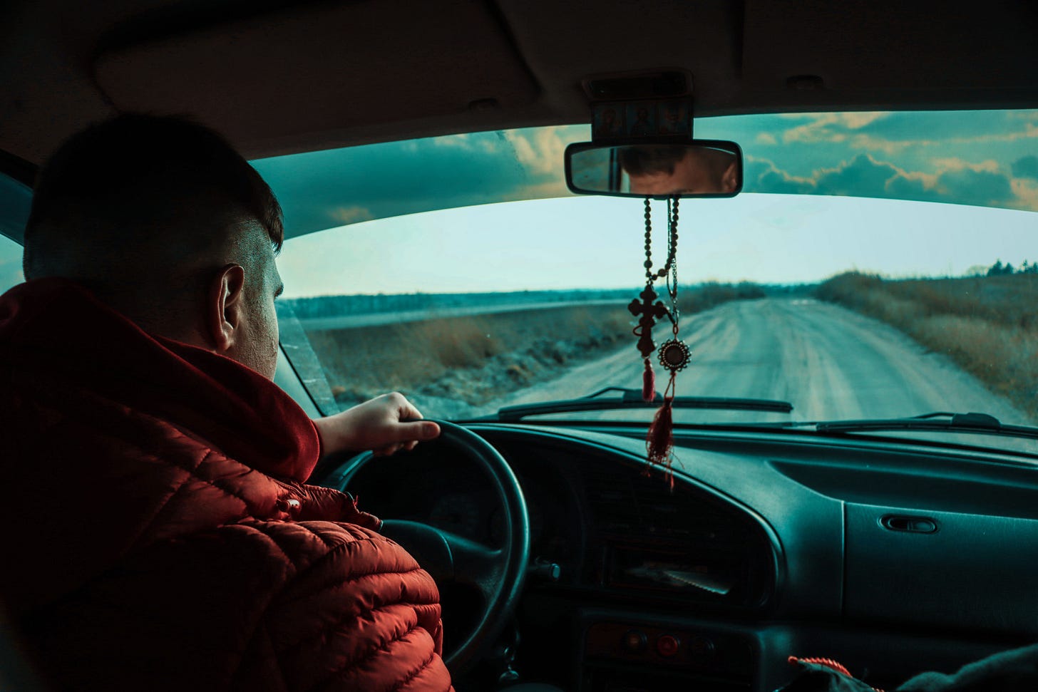Founder driving alone on a rural road, representing the responsibility of leading Go-To-Market before a scalable revenue system exists. Founder driving alone on a rural road, representing the responsibility of leading Go-To-Market before a scalable revenue system exists.
