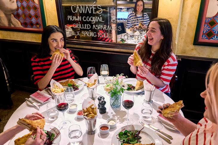 People in stripey tops eating croque monsieurs People in stripey tops eating croque monsieurs