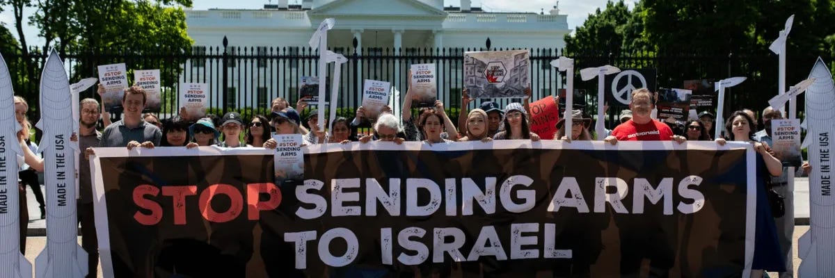 Signs says "Stop Sending Arms to Israel" Signs says "Stop Sending Arms to Israel"