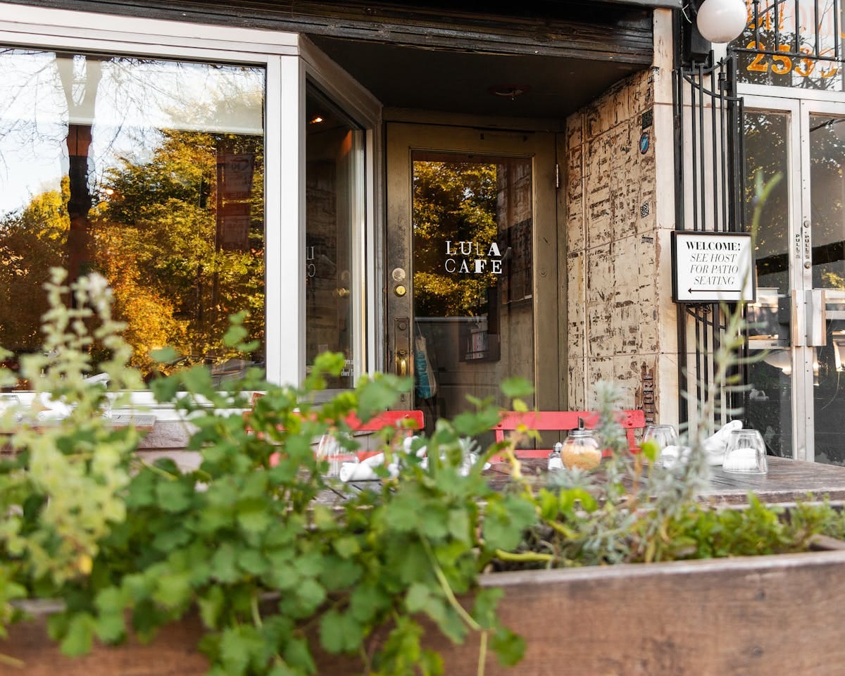 a vase of flowers sits in front of a building a vase of flowers sits in front of a building