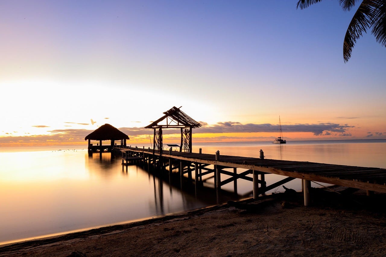 doc, palapa and sunset in Belize