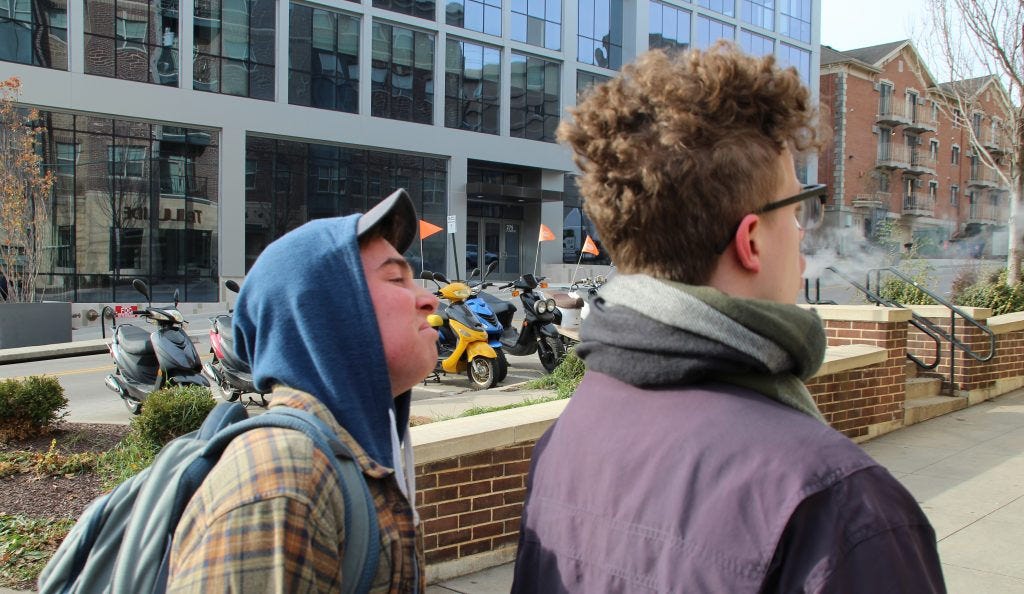 person sniffs vape air