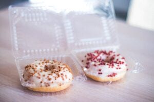 donuts in plastic clamshell containers
