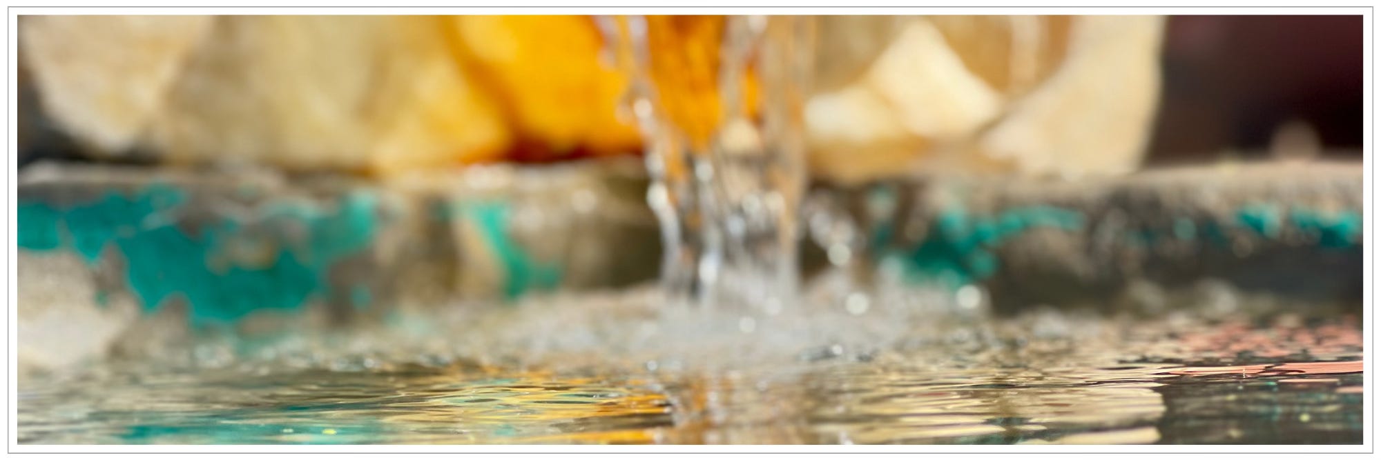 water pouring from fountain into urn