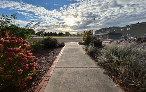 signs, sidewalk, sky, statues