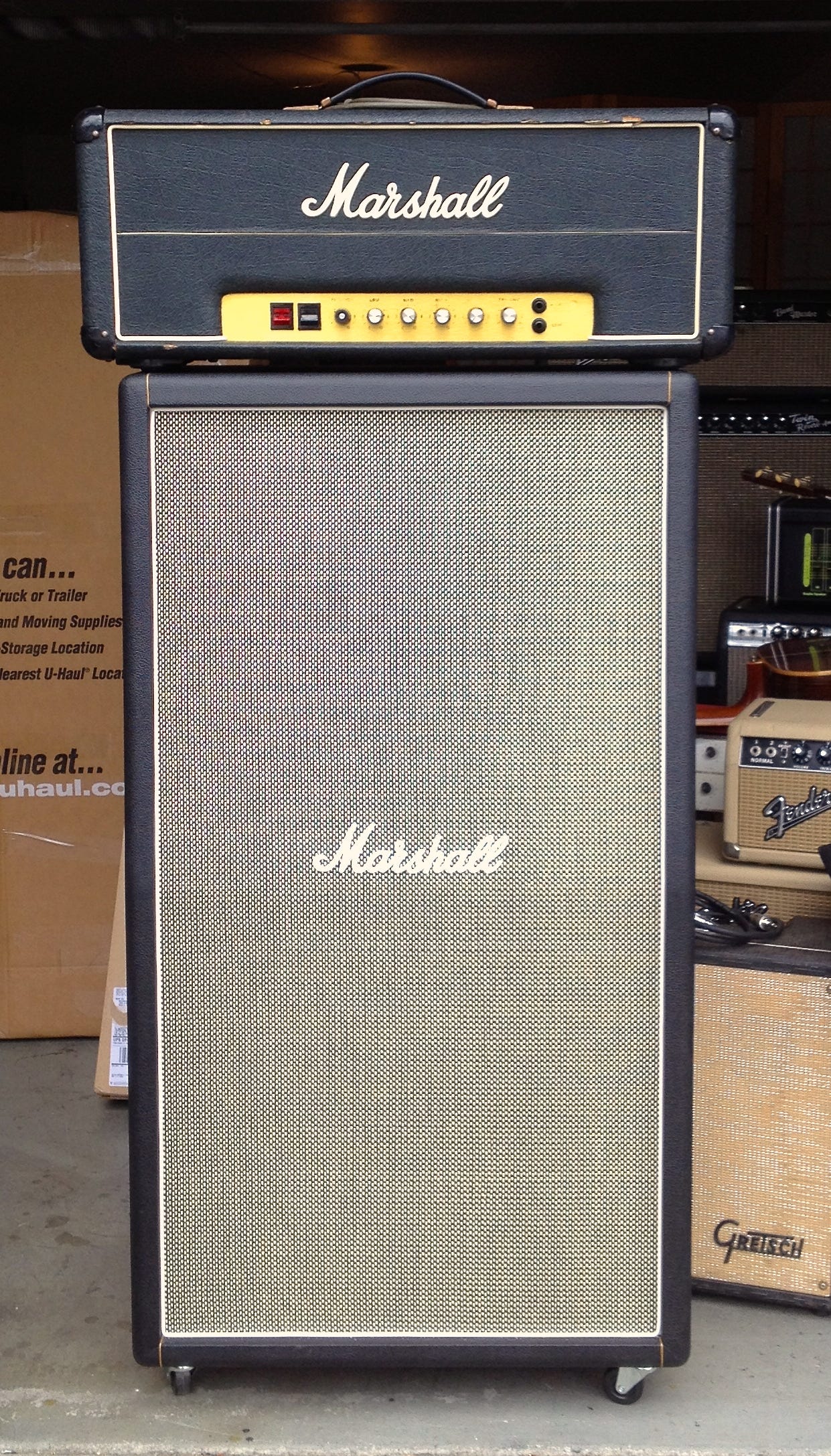 Marshall amp head and cabinet, iconic black and gold design, perfect for rock concerts and recording studios.
