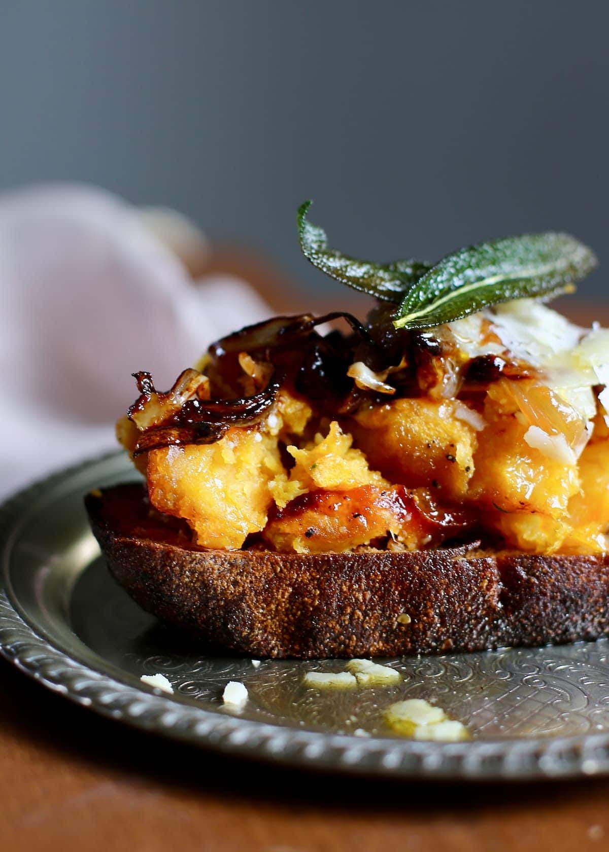 a squash toast on a silver tray, a close up shot showing all the ingredients.