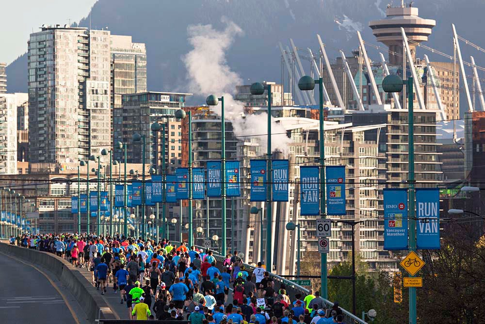 Vancouver BMO half marathon runners on Cambie Bridge heading into downtown.
