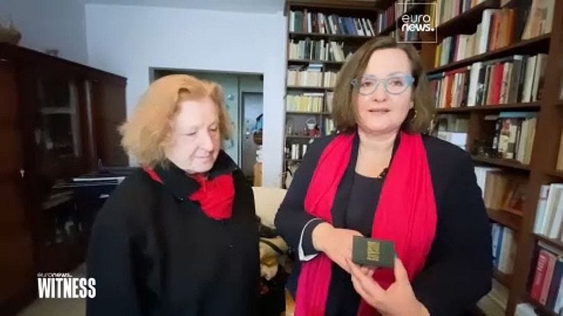 Publisher Elżbieta (L) with writer Renata (R) holding a box containing their wedding rings