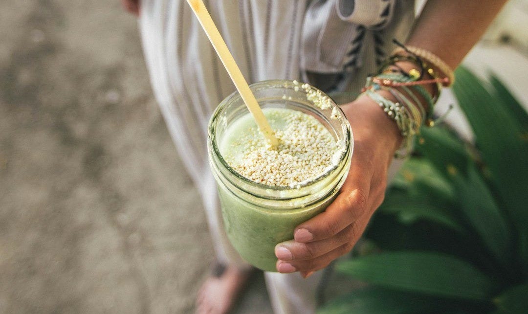 person holding glass cup person holding glass cup