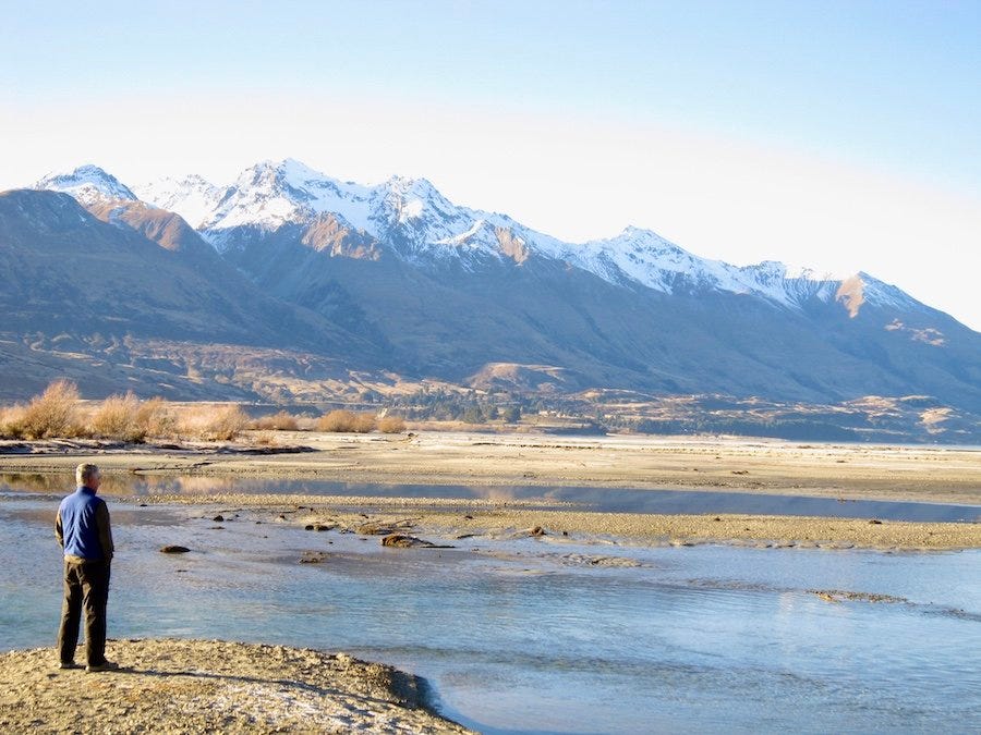 Man looking at mountains finding peace