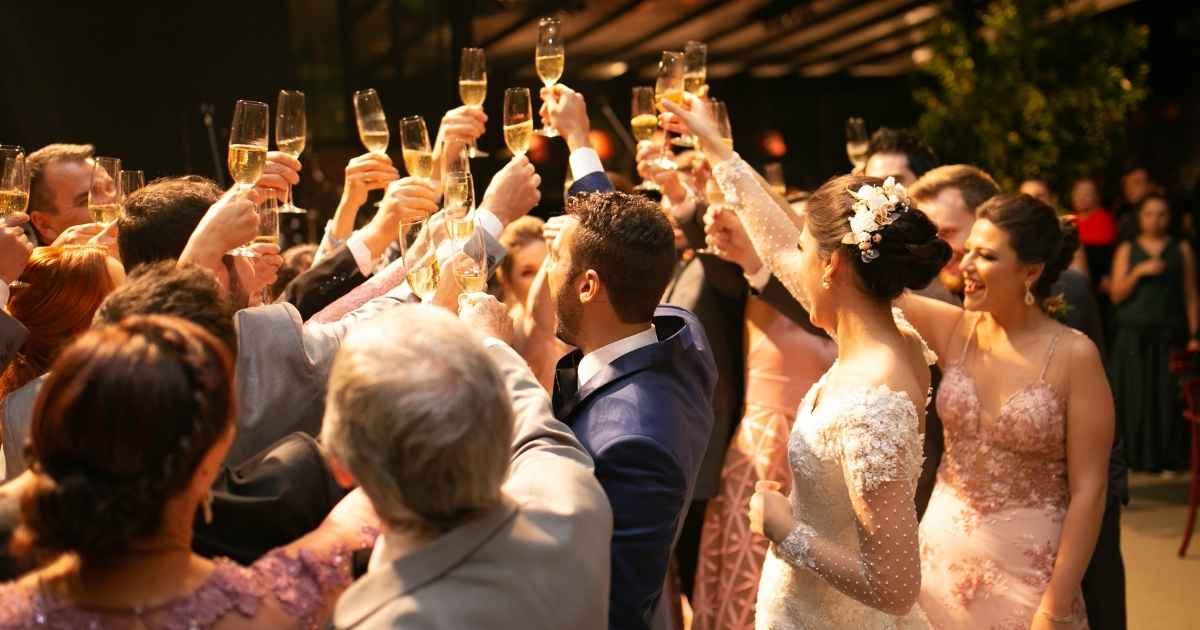 Bride, groom and wedding guests making a toast