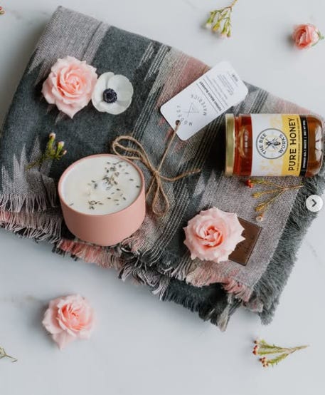 gift basket, rows of succulent plants in pots, flat lay of candles, blanket, roses and honey