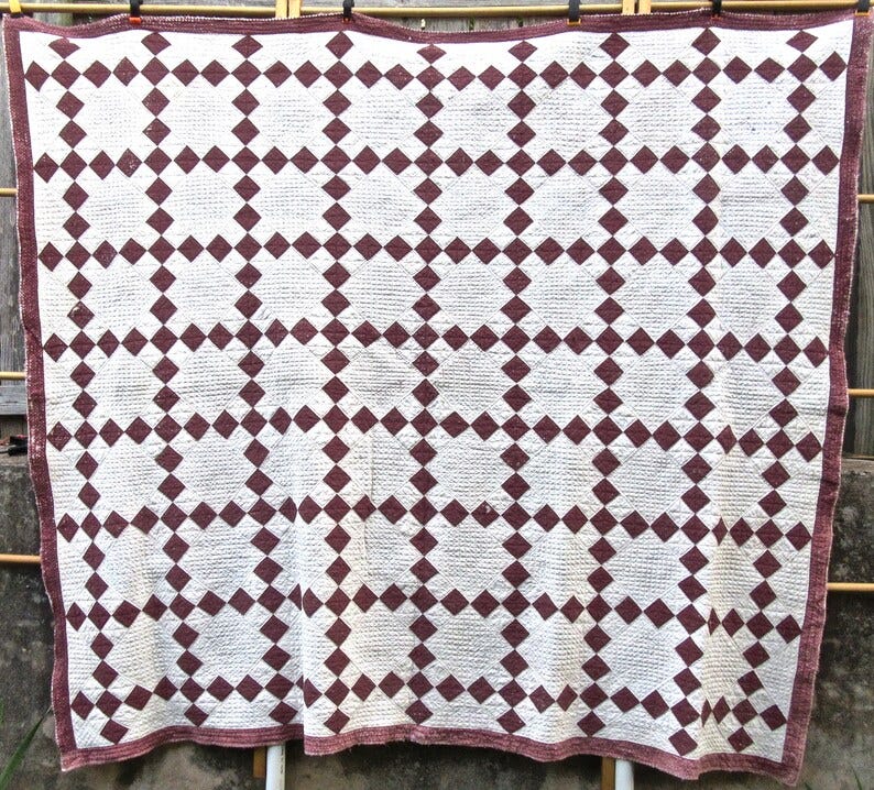 May include: A white and brown quilt with a diamond pattern. The quilt is made of squares with a diamond pattern in the center of each square. The quilt is hanging on a clothesline. May include: A white and brown quilt with a diamond pattern. The quilt is made of squares with a diamond pattern in the center of each square. The quilt is hanging on a clothesline.