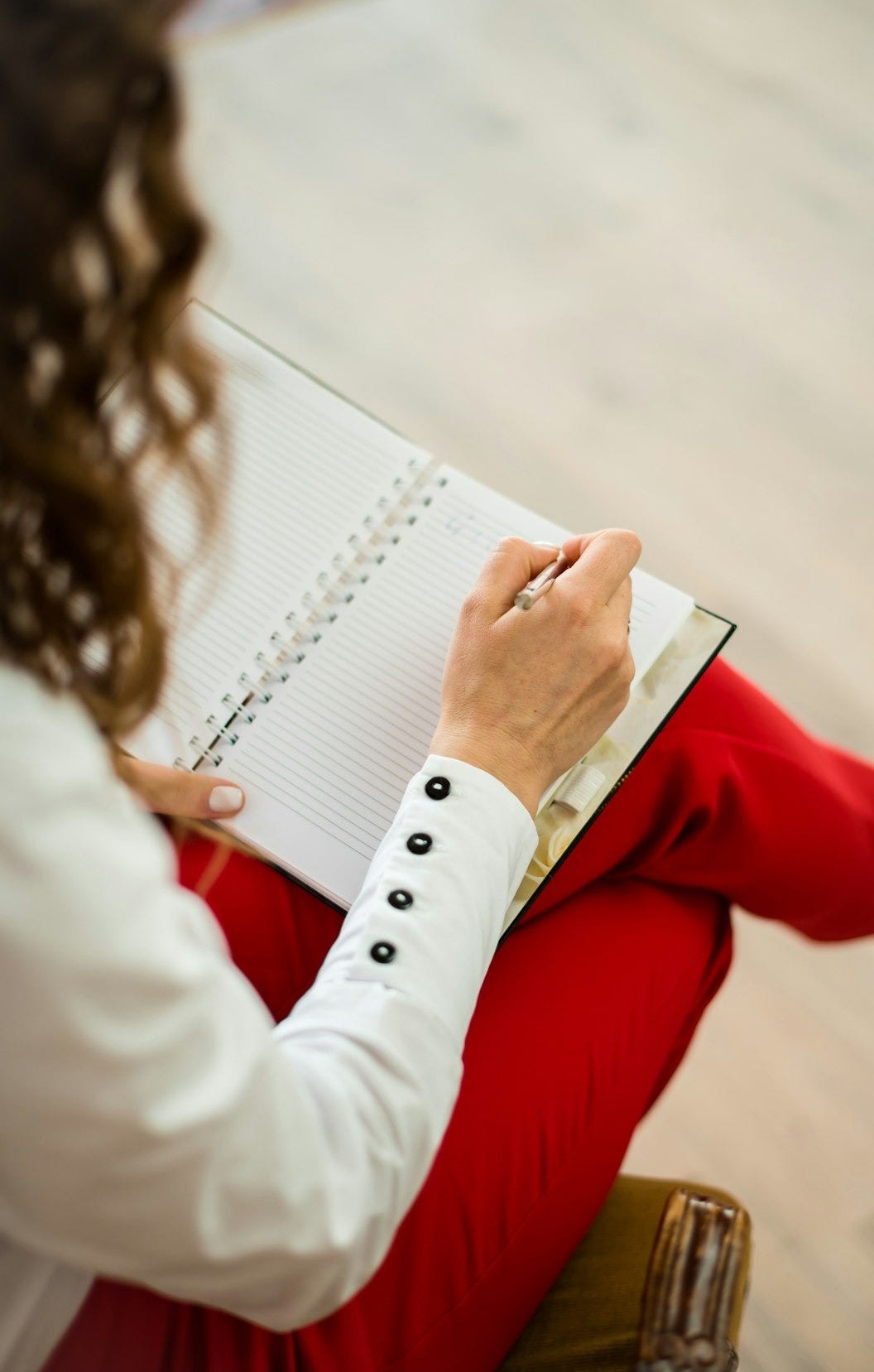 woman in red blazer holding white paper