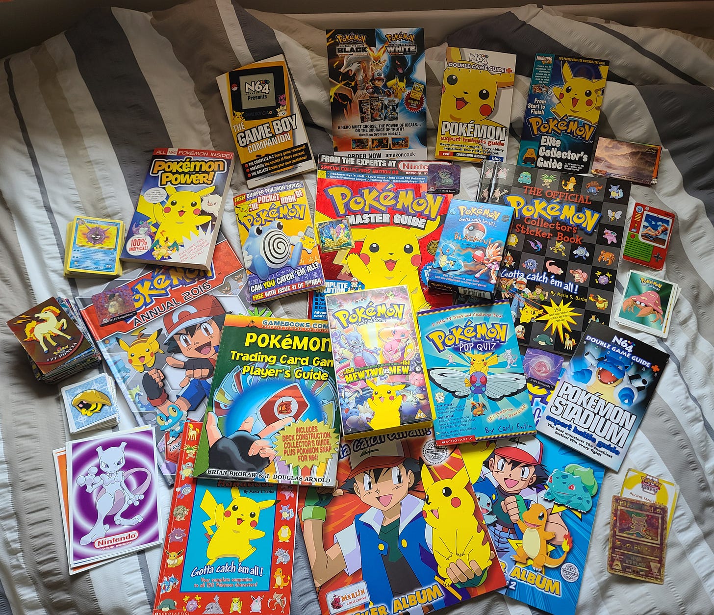 SteC shared a treasure trove of other items from his Pokémon collection, featuring plenty of love from the 90s, such as stickers, Topps trading cards, magazines, game guides, an Ancient Mew card, and a Base Set Blackout theme deck!