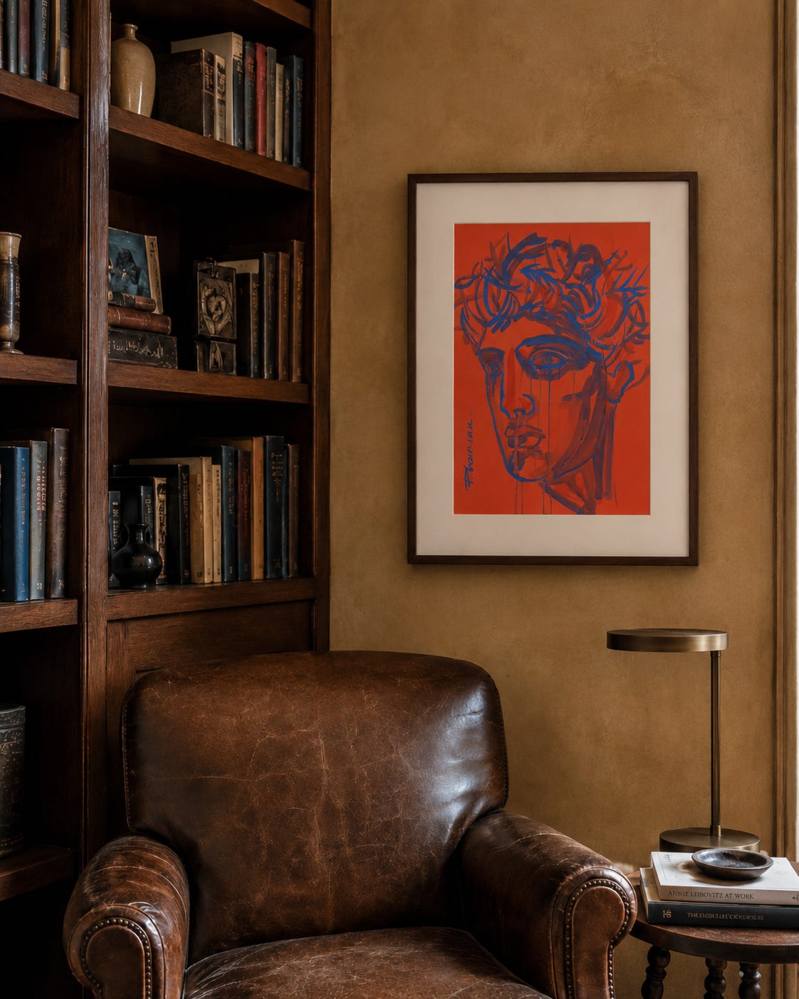 Blue Tears framed with a wide warm-white mat and slim dark-walnut frame beside a dark wood bookcase and vintage brown leather club chair.