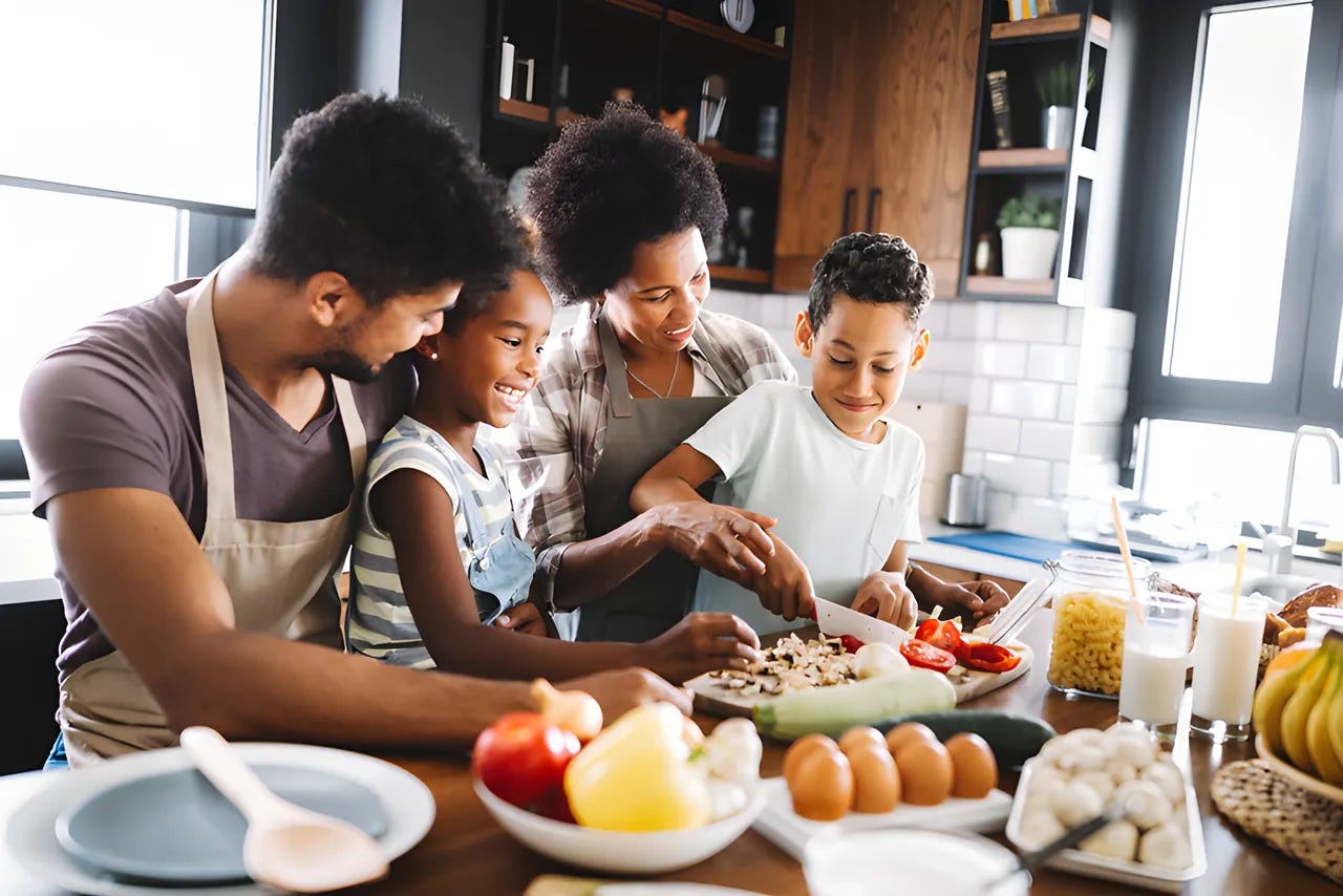 Family with two children preparing dinner together.