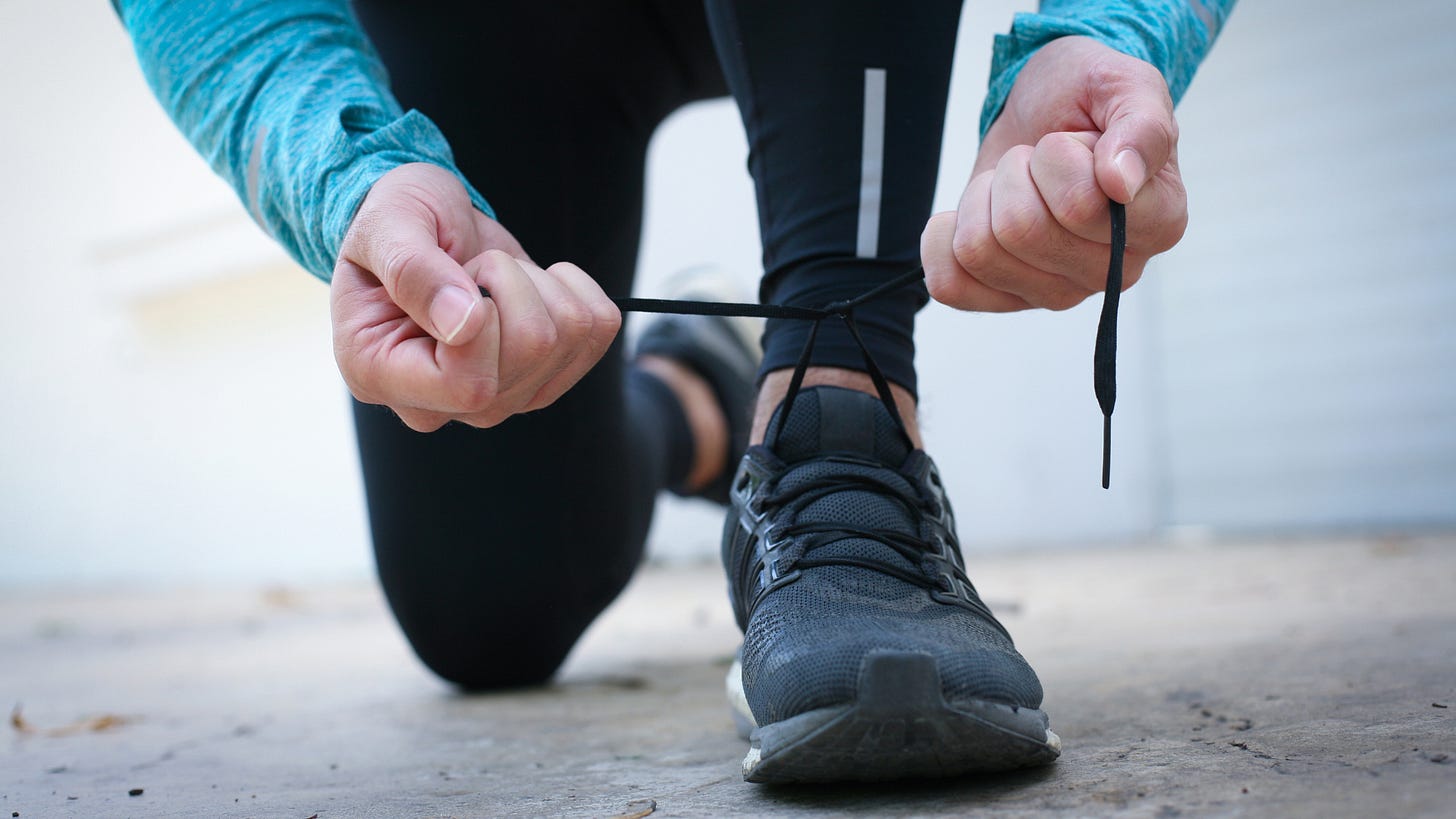 Man tying his running shoes