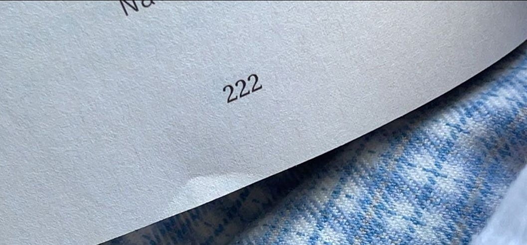 This may contain: two pieces of paper sitting on top of a blue and white cloth covered tablecloth