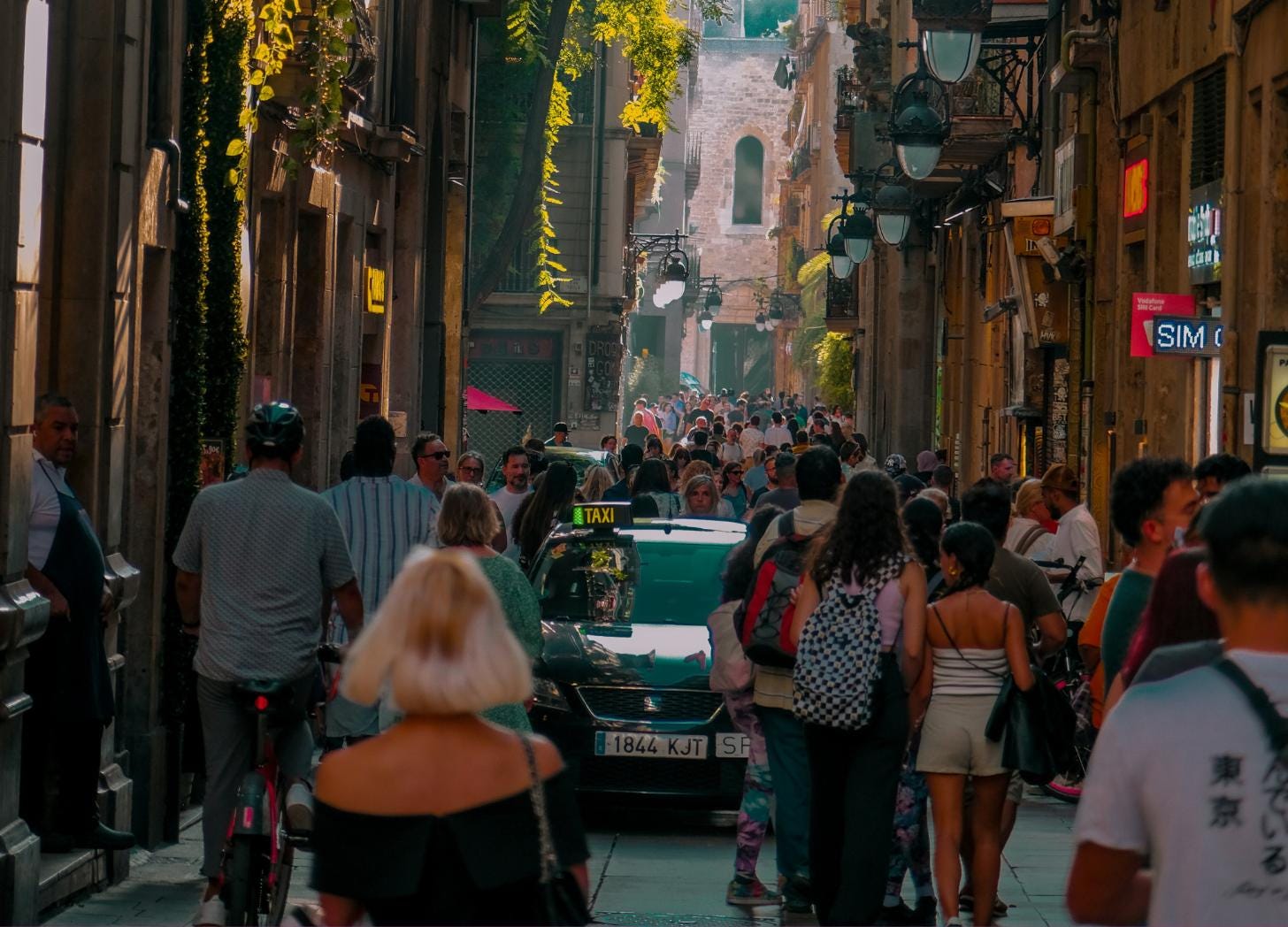 Crowded street in Barcelona showing tourist density that led to the city's visitor coordination system Crowded street in Barcelona showing tourist density that led to the city's visitor coordination system