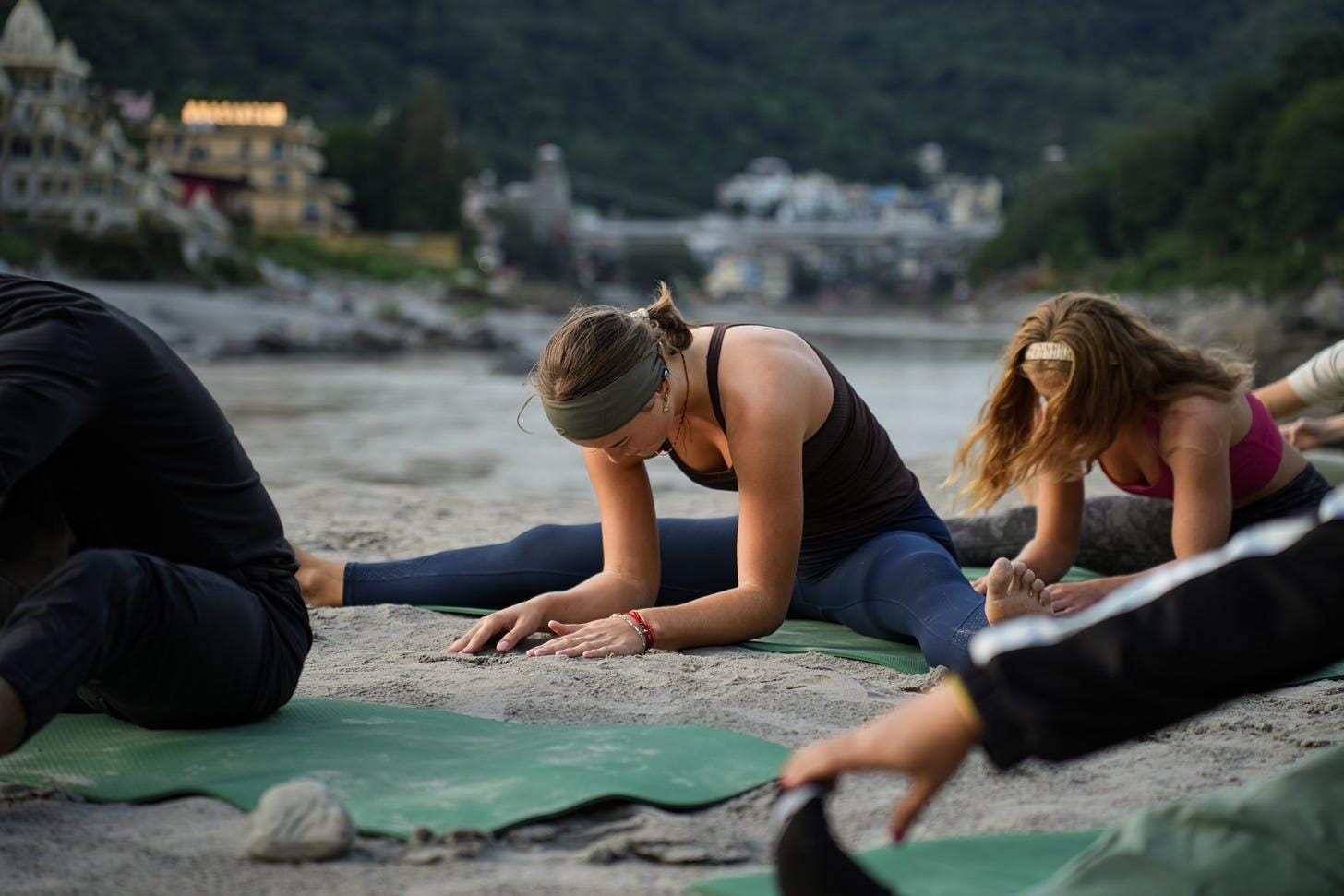 A group of people doing yoga on the beach
Description automatically generated A group of people doing yoga on the beach
Description automatically generated