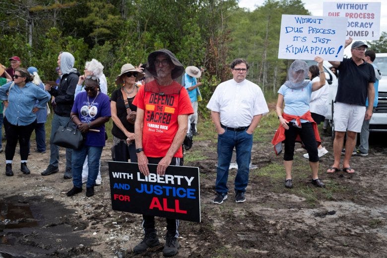 People attend a vigil in support of immigration detainees at the entrance of "Alligator Alcatraz" Immigration and Customs Enforcement, ICE, detention center at the Dade-Collier Training and Transition Airport in Ochopee, Fla., Aug. 10, 2025. 