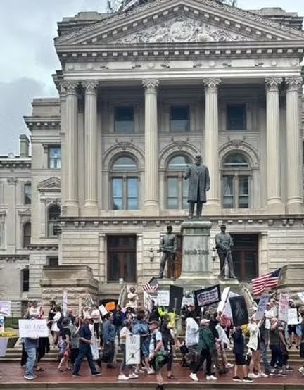 The No Kings rally crowd standing outside the statehouse in Indianapolis.