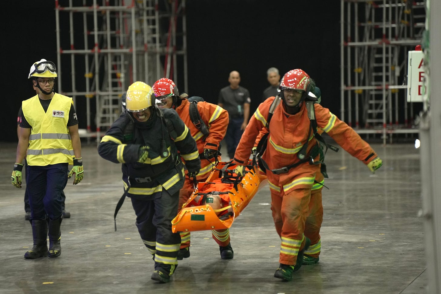 A team of lifesavers evacuated the victims to a safe area before giving further treatment, during the Singapore-Global Firefighters & Paramedics Challenge A team of lifesavers evacuated the victims to a safe area before giving further treatment, during the Singapore-Global Firefighters & Paramedics Challenge