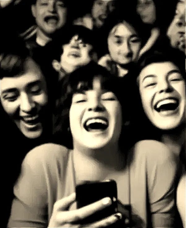 Group of people laughing while using their phones