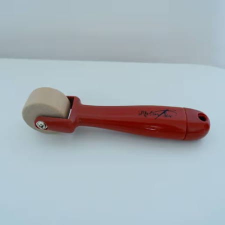wooden seam roller by madamsew on a white table
