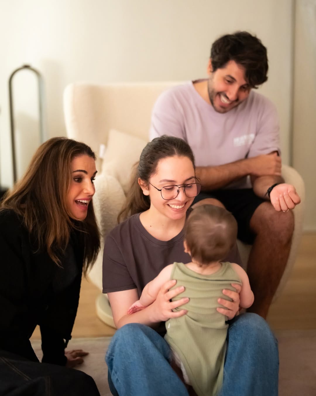 Queen Rania looking at her grandaughter smiling
