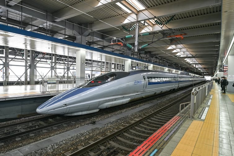 A high-speed train in a station. A high-speed train in a station.