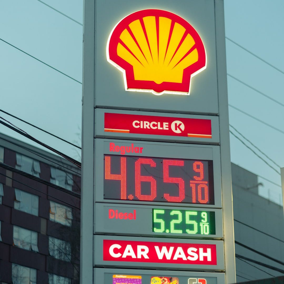 a sign for a gas station in a city